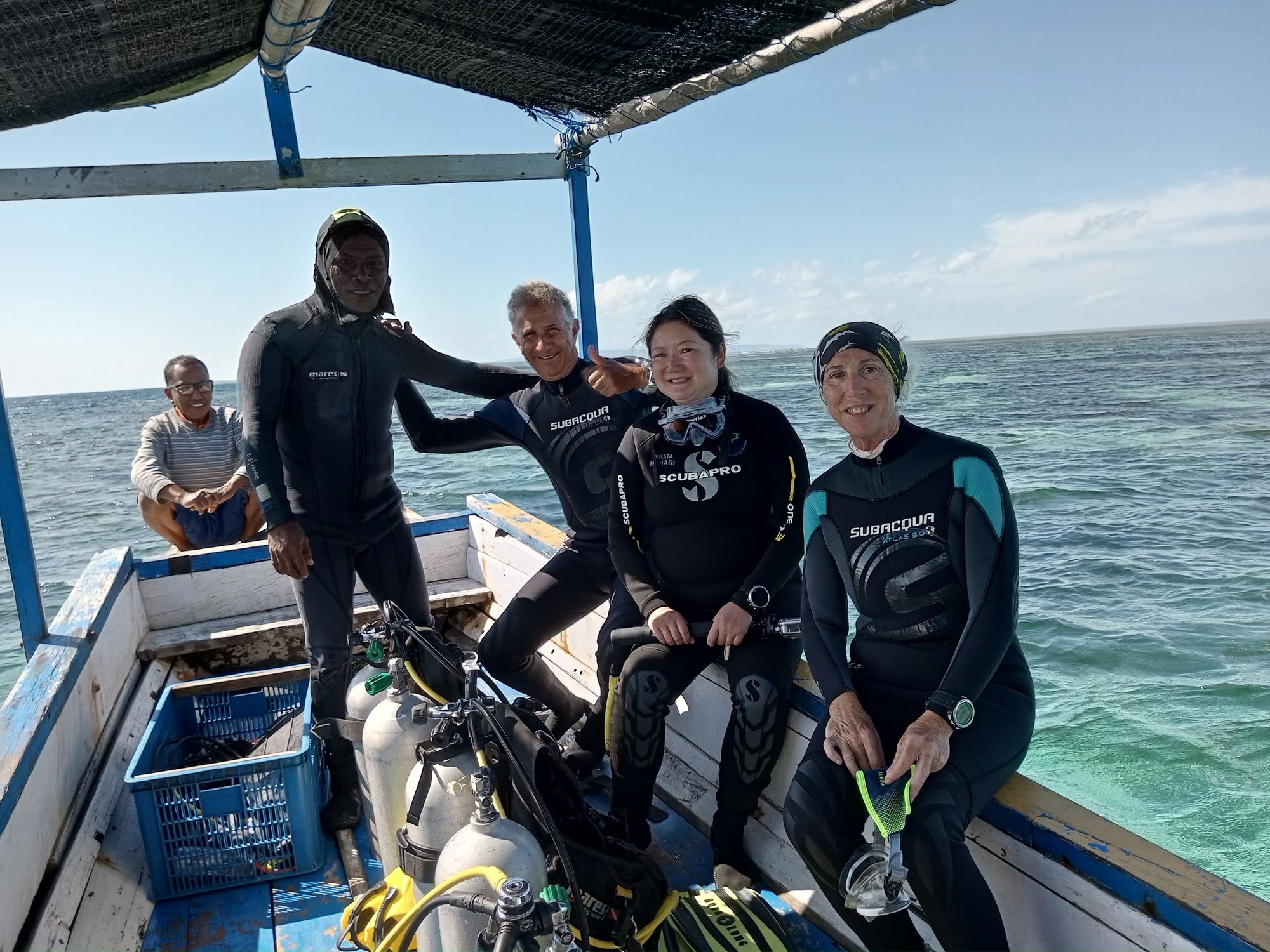 Divers kitted up on the boat, ready to roll in